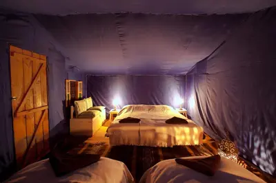 a bedroom with two beds in a tent at Bivouac La Dune Blanche in Mhamid
