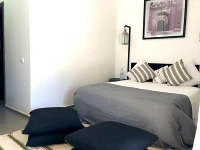 a bedroom with a bed and two pillows at Palais Akki in Marrakech