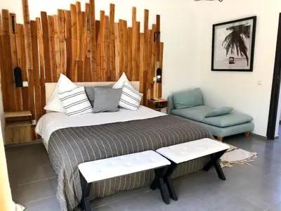 a bedroom with a bed and a blue chair at Palais Akki in Marrakech
