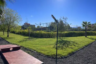 a park with a bench and a street light at Les Orangers De l'Ourika in Marrakech