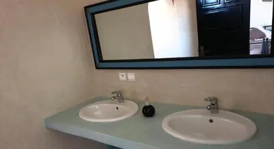 a bathroom with two sinks and a mirror at Les Orangers De l'Ourika in Marrakech