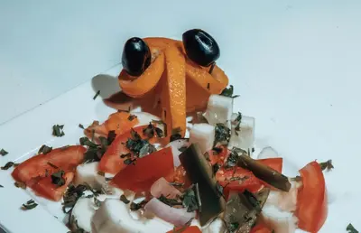 a pile of vegetables on a white plate at Moonlight Luxury Camp in Merzouga