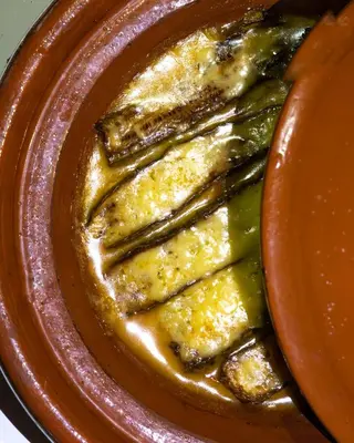 a brown plate of food with pickles on it at Moonlight Luxury Camp in Merzouga