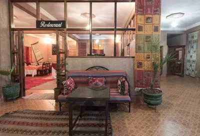 a lobby with a couch and a table in a room at Kasbah Valentine in Aït Ben Haddou