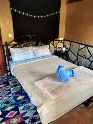 a bed with a blue item sitting on top of it at auberge restaurant tizgui in Tinerhir