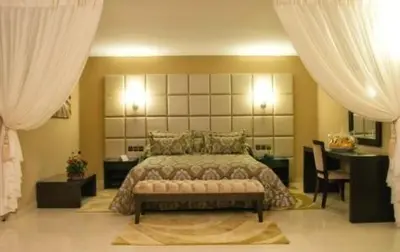 a bedroom with a large bed and a table at Chems Du Lac Bin El Ouidane in Bine el Ouidane