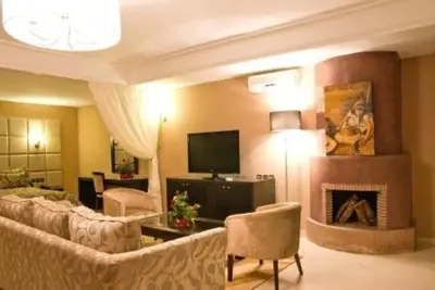 a living room with a couch and a fireplace at Chems Du Lac Bin El Ouidane in Bine el Ouidane