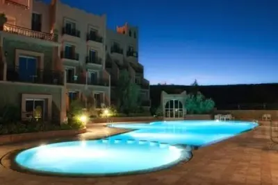 a large swimming pool in front of a building at Chems Du Lac Bin El Ouidane in Bine el Ouidane