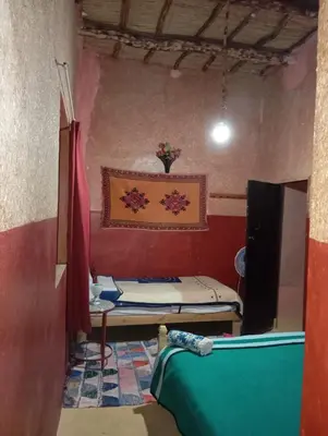 a small room with a bed and a tv at Kasbah tifaoute ait Ben haddou in Aït Ben Haddou