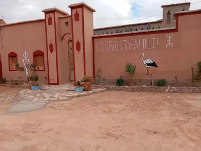 a building with a bird painted on the side of it at Kasbah tifaoute ait Ben haddou in Aït Ben Haddou