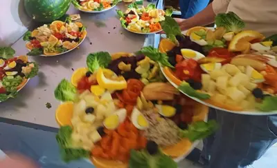 a table full of plates of different types of food at Dounia Hostel in Tinerhir