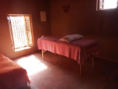 a small room with a table and a window at Dar Paru in Mhamid