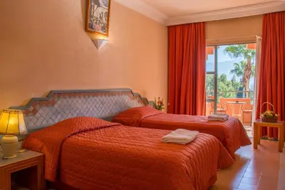 a hotel room with two beds and a window at Chems Le Tazarkount in Afourer