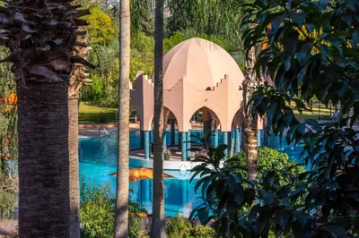 a mosque in the middle of a pool with trees at Chems Le Tazarkount in Afourer