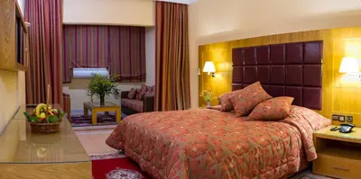 a hotel room with a bed and a living room at Chems Le Tazarkount in Afourer