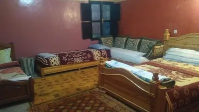 a living room with two beds and a couch at Le Lion D'or Atlas in Telouet