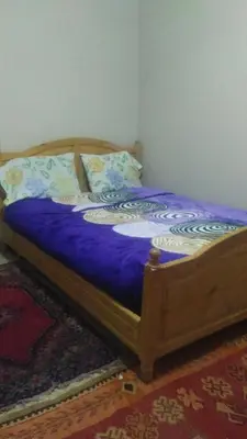 a bedroom with a bed with purple sheets and pillows at Le Lion D'or Atlas in Telouet
