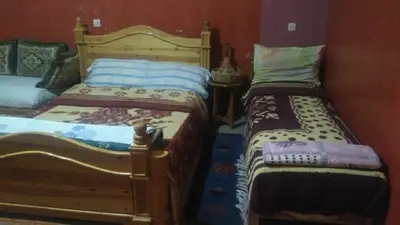 two twin beds in a room with at Le Lion D'or Atlas in Telouet