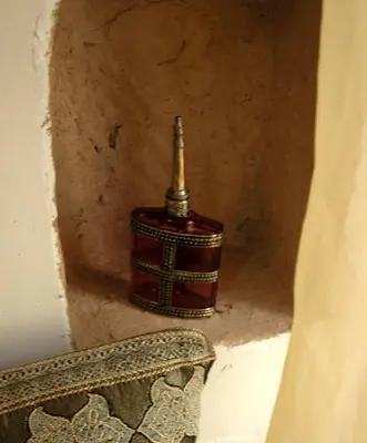 a small bottle sitting on the corner of a wall at Kasbah Iswan in Kalaat MGouna