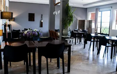 a dining room filled with tables and chairs at Villa Agapanthe in Fès
