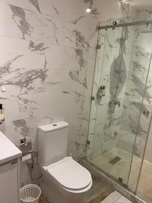 a bathroom with a toilet and a shower at Hotel La Perle du Sud in Ouarzazate