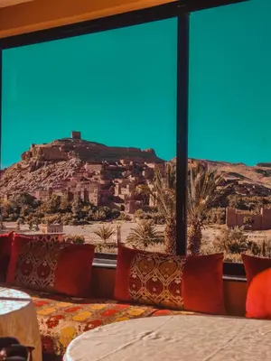 a bedroom with a view of a mountain at Hôtel LAKASBAH Ait Ben Haddou in Aït Ben Haddou