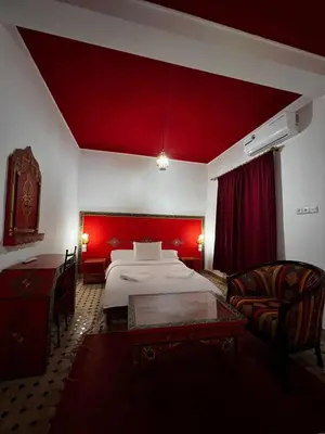 a room with a bed and a red ceiling at Hôtel LAKASBAH Ait Ben Haddou in Aït Ben Haddou