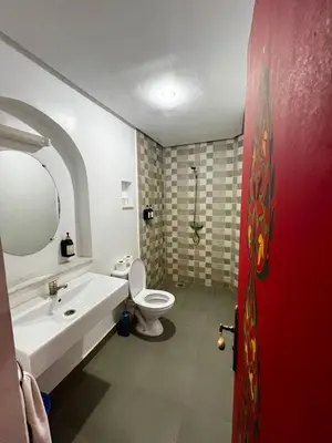 a bathroom with a white sink and a toilet at Hôtel LAKASBAH Ait Ben Haddou in Aït Ben Haddou