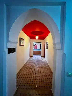 a hallway with a red ceiling in a house at Hôtel LAKASBAH Ait Ben Haddou in Aït Ben Haddou