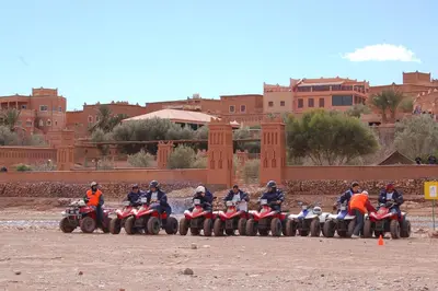 a group of people riding on atvs and motorcycles at Hôtel LAKASBAH Ait Ben Haddou in Aït Ben Haddou