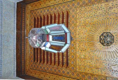 a wooden wall with a light on it at Riad Les Remparts De Fès in Fès