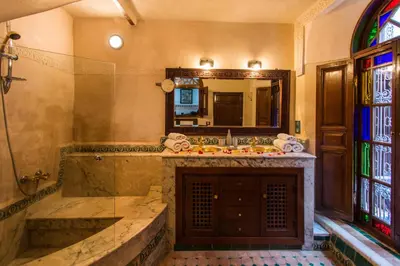 a bathroom with a sink and a mirror at Riad Les Remparts De Fès in Fès