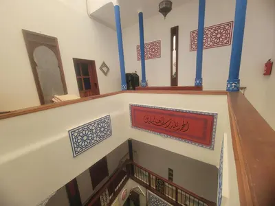 a room with a staircase with a red sign on it at Riad Dar Lemdrssa in Fès