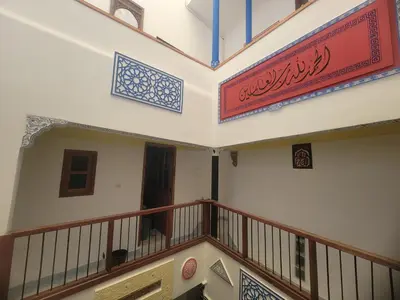 a building with a balcony with a sign on it at Riad Dar Lemdrssa in Fès