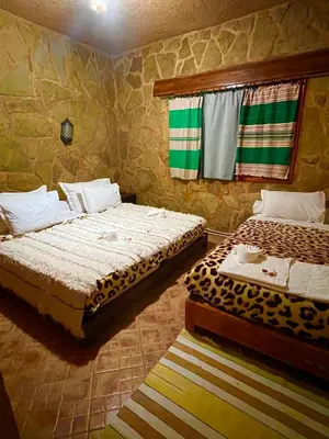 a bedroom with two beds and a window at Ferme D’hôte La Vallée in Azrou