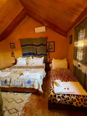 a bedroom with two beds in a room at Ferme D’hôte La Vallée in Azrou