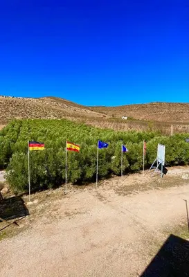 a group of flags on poles in a field at Ferme D’hôte La Vallée in Azrou
