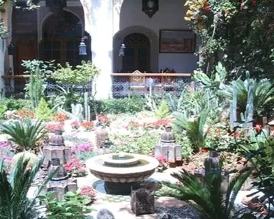 a garden with a fountain in the middle of a building at Le Riad Meknes in Meknès