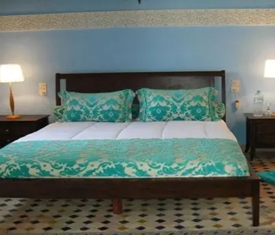 a bedroom with a large bed with a blue light at Le Riad Meknes in Meknès