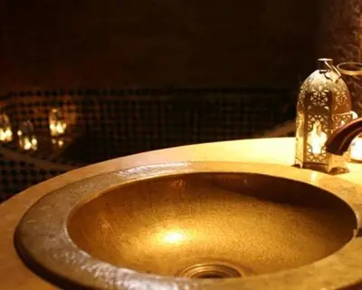 a bathroom sink with a faucet on top of it at Le Riad Meknes in Meknès