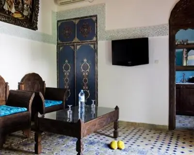 a living room with a couch and a coffee table at Le Riad Meknes in Meknès