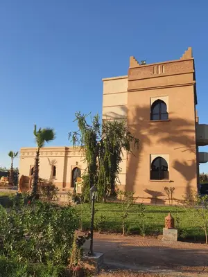 a building with a tree in front of it at Villa Diaf Johanne in Aït Ourir
