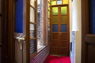 an open door to a room with colorful glass at Dar Settash in Fès