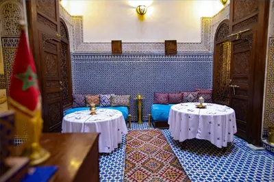 a room with two tables and chairs in a room at Dar Settash in Fès