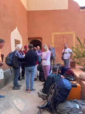 a group of people standing around a pile of luggage at Gîte d'étape Tamaloute in Bou Tharar