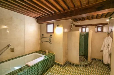a large bathroom with a tub and a shower at Ryad Mabrouka in Fès