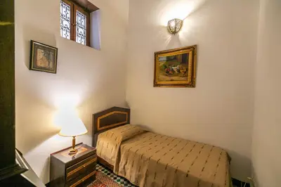 a small bedroom with a bed and a window at Ryad Mabrouka in Fès