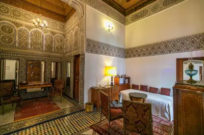 a bedroom with a bed and a desk in a room at Ryad Mabrouka in Fès