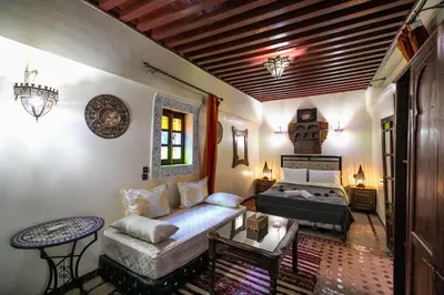 a living room with a couch and a bed at Dar El Yasmine in Fès