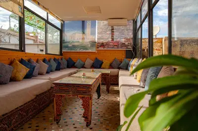 a room with couches and a table and windows at Dar El Yasmine in Fès